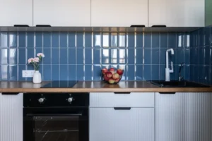 A Blue Modular Kitchen with a Tiled Backsplash